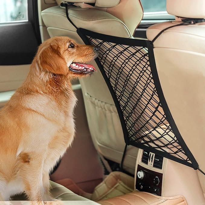 A 3-layer black car mesh organizer being used to store dog-related items while a dog sits in the foreground in a car setting.