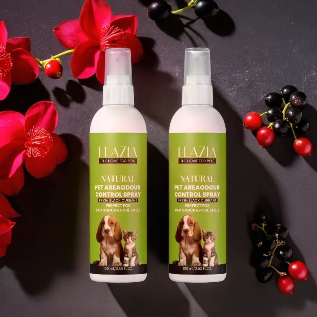 Two bottles of FLAZIA Pets Natural Pet Area Odor Control Spray placed on a surface with decorative flowers and berries around them.