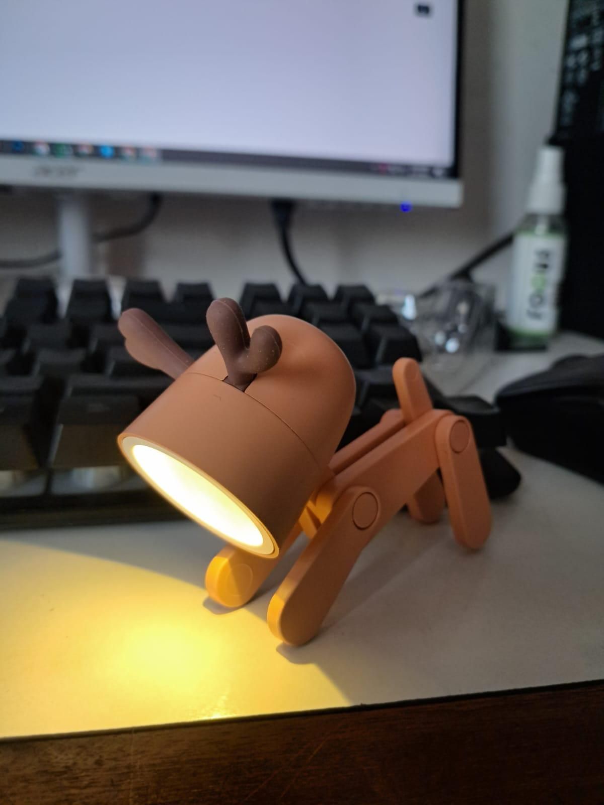 Dog-shaped lamp on a desk with a computer monitor in the background