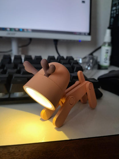 Dog-shaped lamp on a desk with a computer monitor in the background