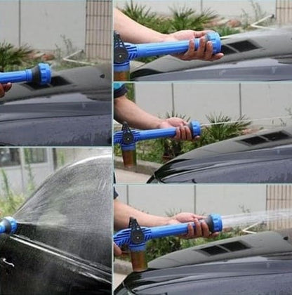 Water spraying from high-pressure spray gun for powerful cleaning of driveway or patio.