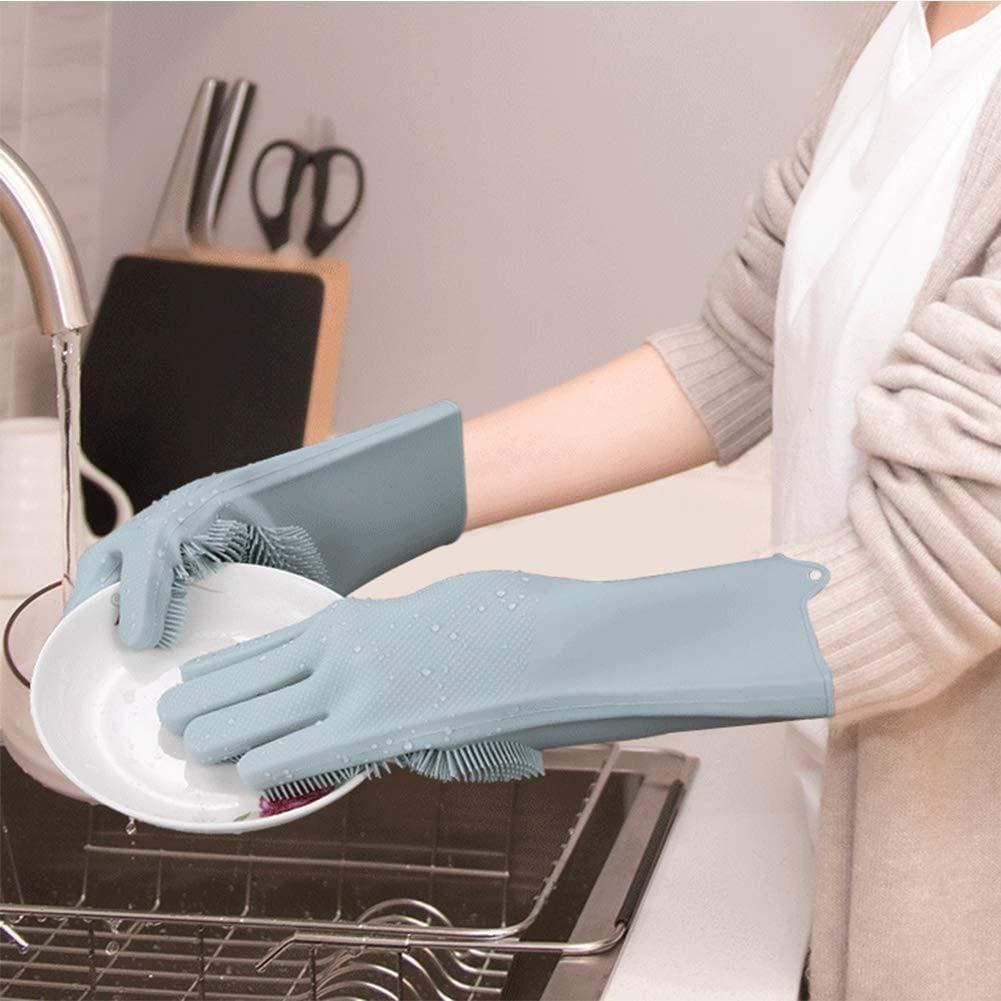 Person wearing blue gloves with scrubbing surfaces, washing a plate in a kitchen.